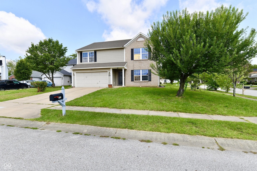 view of front facade with a garage and a front lawn