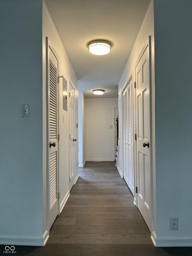 corridor featuring dark hardwood / wood-style floors