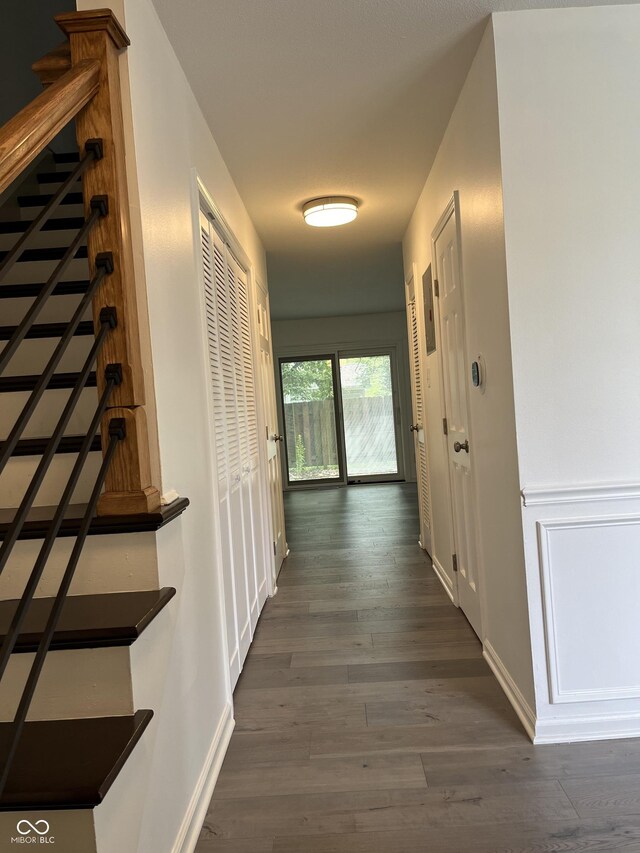 hallway with dark hardwood / wood-style floors