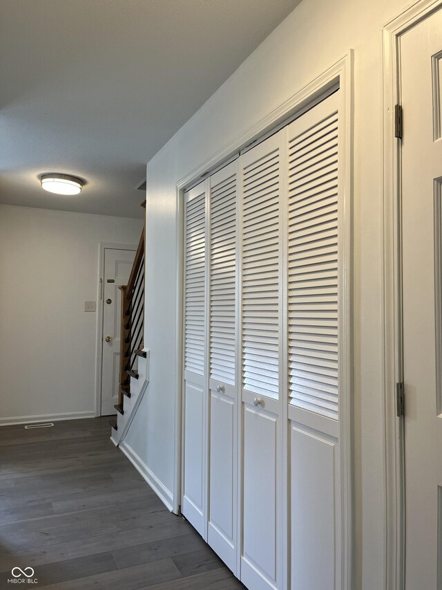 corridor with dark hardwood / wood-style flooring