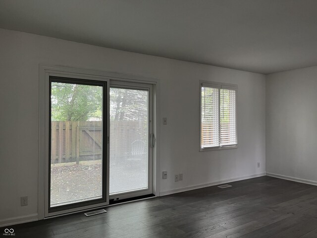 unfurnished room featuring dark wood-type flooring