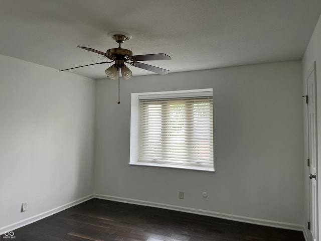 empty room with dark hardwood / wood-style floors and ceiling fan