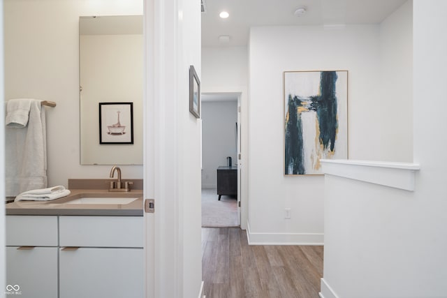 bathroom featuring hardwood / wood-style flooring and vanity