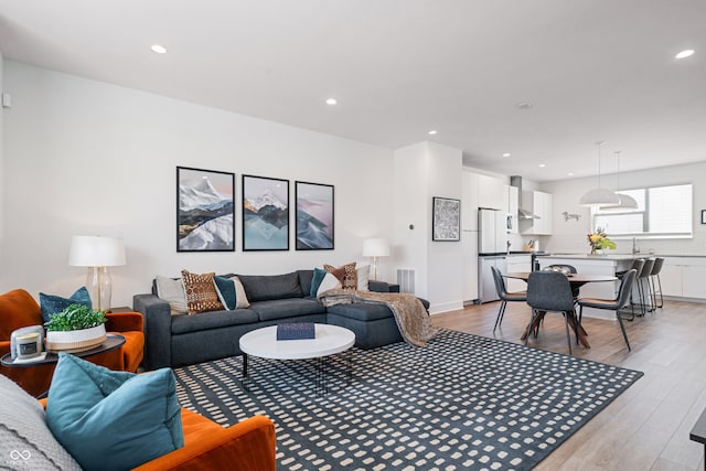 living room with sink and light hardwood / wood-style flooring