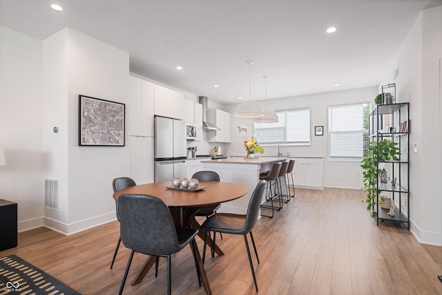 dining room with light hardwood / wood-style flooring