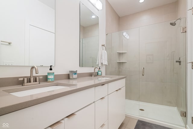 bathroom with tile patterned flooring, double sink vanity, and an enclosed shower