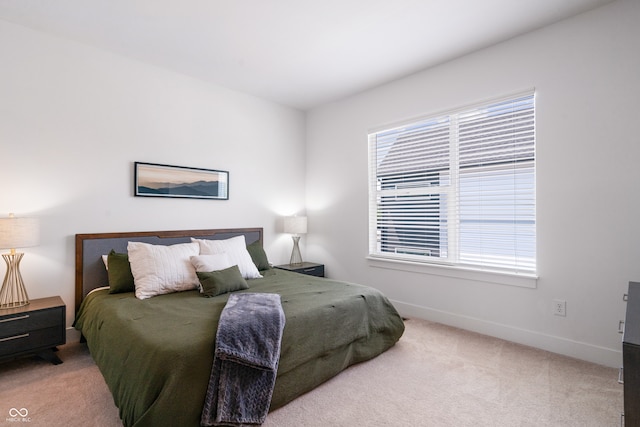 carpeted bedroom featuring multiple windows