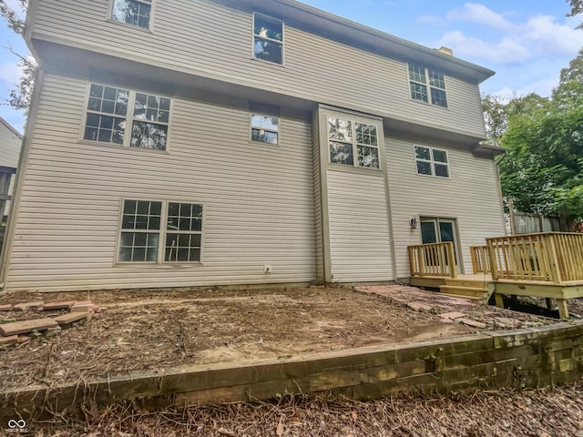 back of house featuring a wooden deck