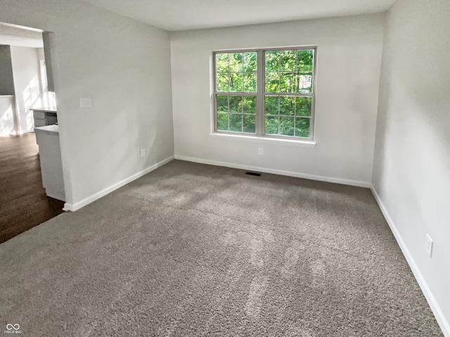 empty room featuring dark carpet