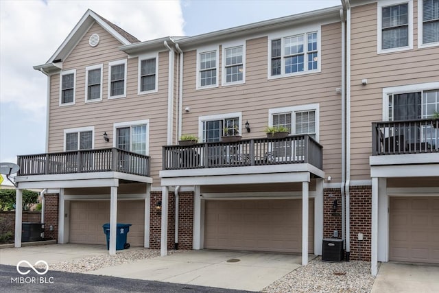 townhome / multi-family property featuring a garage and a balcony