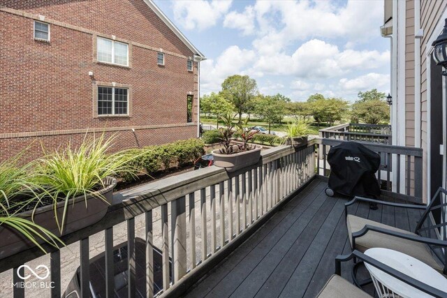 wooden terrace featuring grilling area