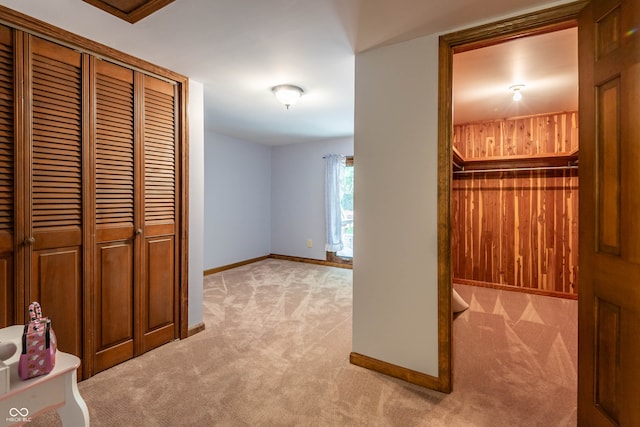 hall featuring light colored carpet