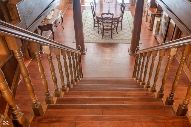 stairway with dark hardwood / wood-style floors