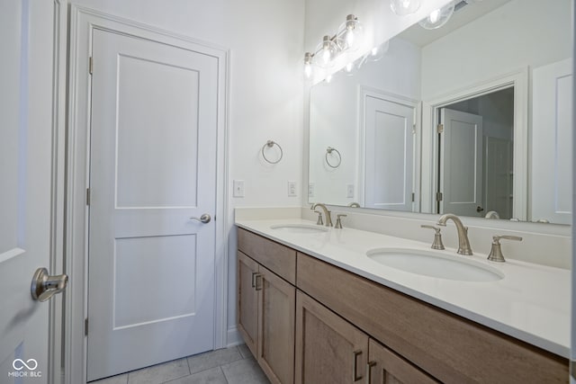 bathroom with tile patterned flooring and dual vanity