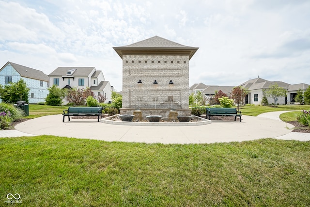 view of property's community with a lawn