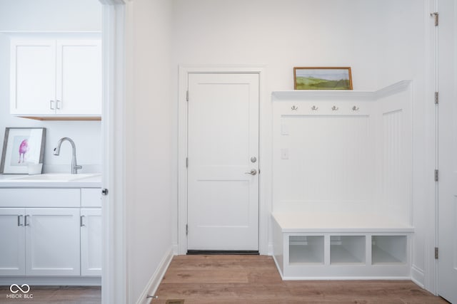 mudroom featuring sink and light hardwood / wood-style flooring