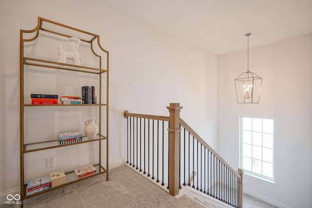 interior space featuring carpet flooring and a chandelier