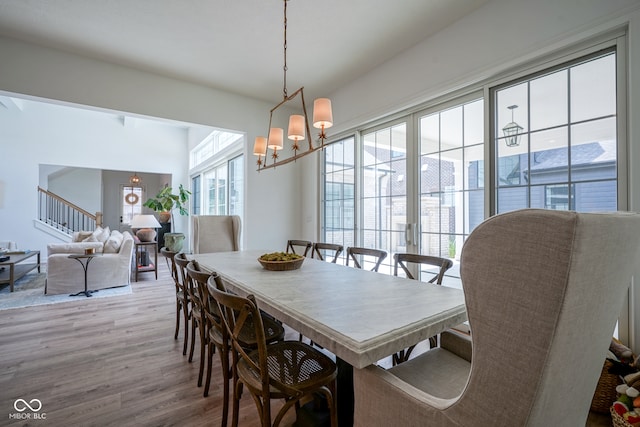 dining area with hardwood / wood-style flooring and a chandelier