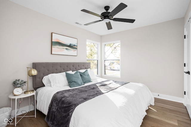 bedroom with dark wood-type flooring and ceiling fan