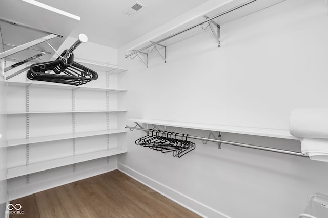 walk in closet featuring dark hardwood / wood-style flooring