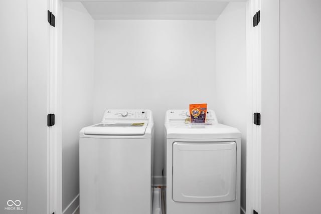 clothes washing area featuring washer and dryer