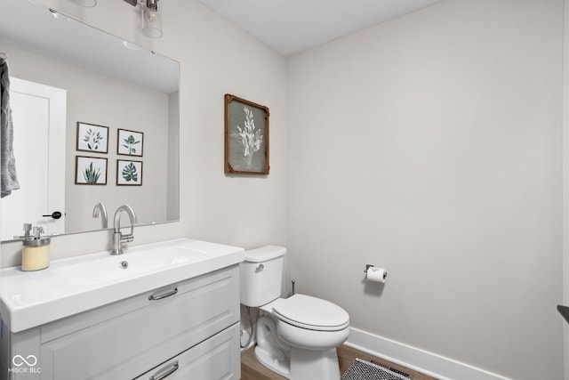 bathroom featuring vanity, toilet, and wood-type flooring