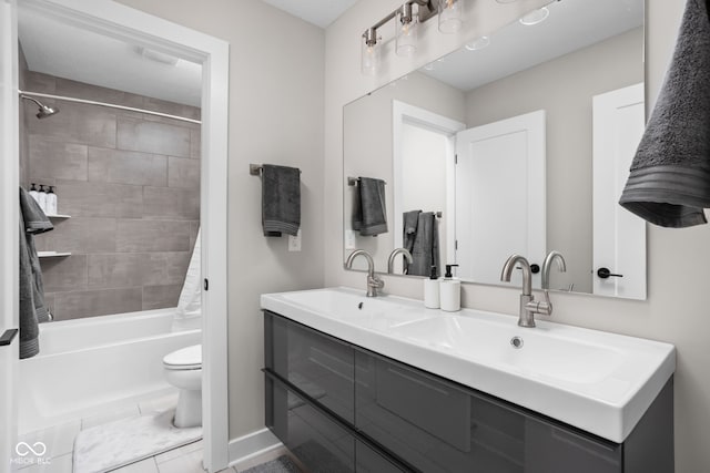 full bathroom with tiled shower / bath combo, vanity, tile patterned flooring, and toilet