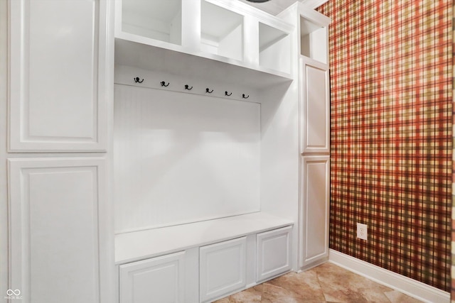 mudroom with baseboards, wallpapered walls, and light tile patterned floors