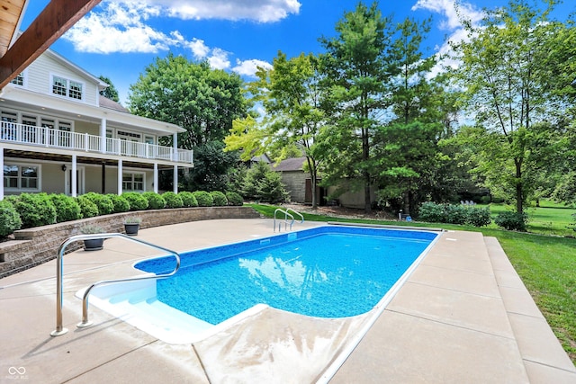 pool featuring a patio and a yard