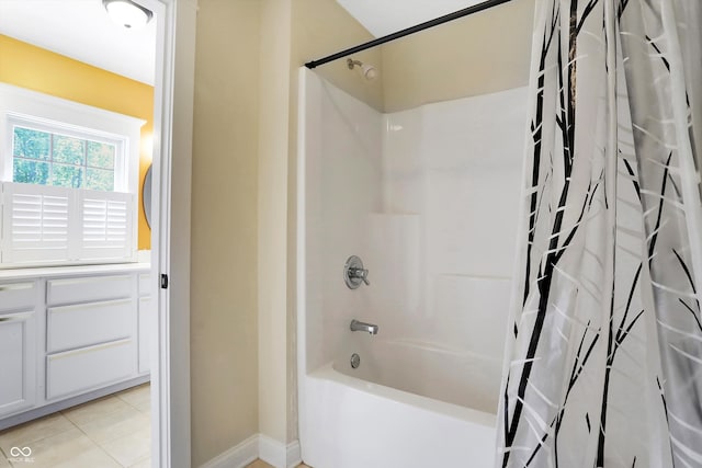 bathroom featuring tile patterned flooring and shower / bath combo