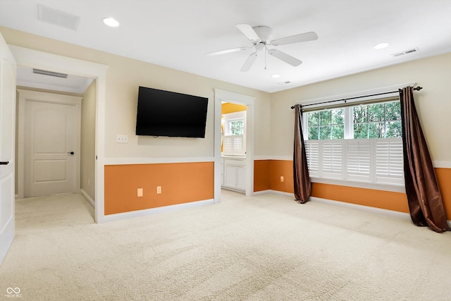 unfurnished living room featuring light colored carpet and visible vents