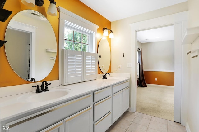 full bath featuring tile patterned floors, double vanity, and a sink