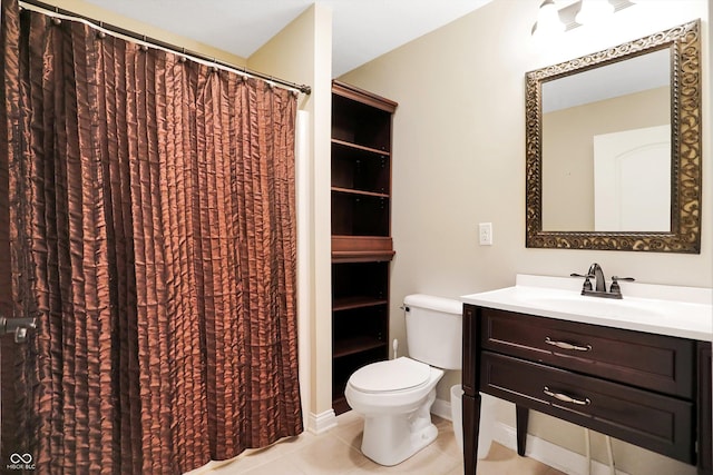 bathroom with baseboards, toilet, tile patterned flooring, and vanity