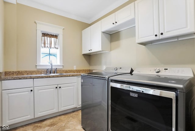 washroom with light tile patterned floors, sink, cabinets, independent washer and dryer, and crown molding