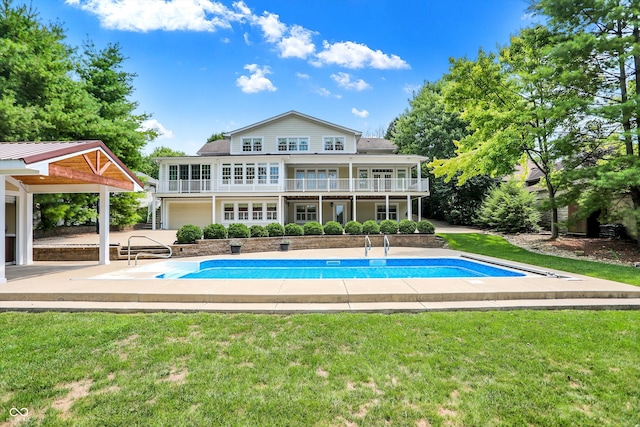 view of pool featuring a patio and a yard