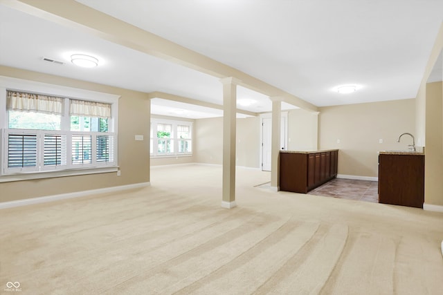 basement with light colored carpet and sink