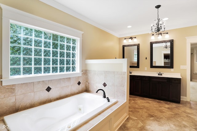 bathroom featuring ornamental molding, an inviting chandelier, tiled tub, and vanity