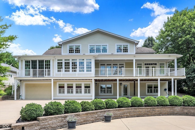 exterior space featuring driveway, a shingled roof, and an attached garage