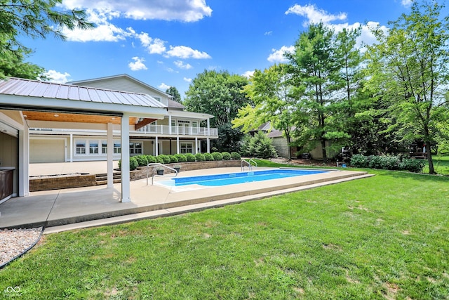 view of swimming pool with a lawn and a patio