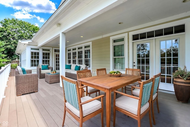 wooden deck with outdoor dining area and outdoor lounge area