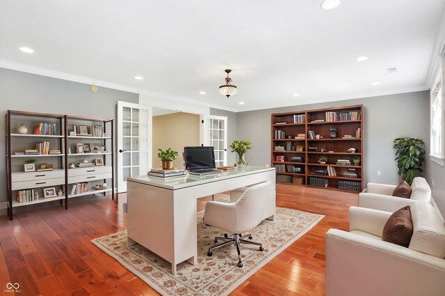 home office with ornamental molding and hardwood / wood-style floors