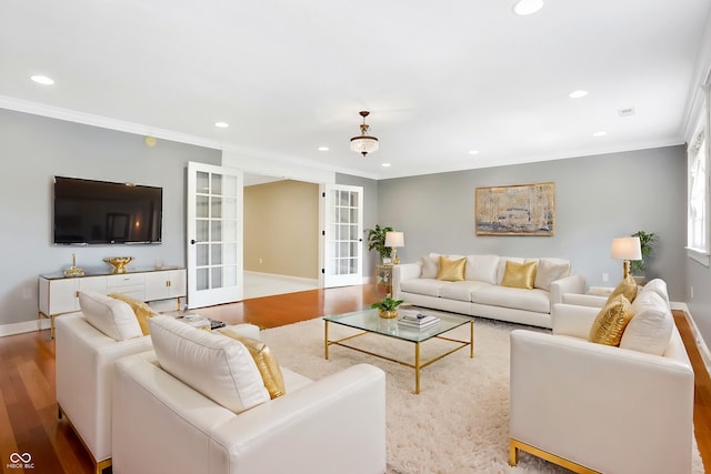 living room featuring recessed lighting, wood finished floors, ornamental molding, and french doors