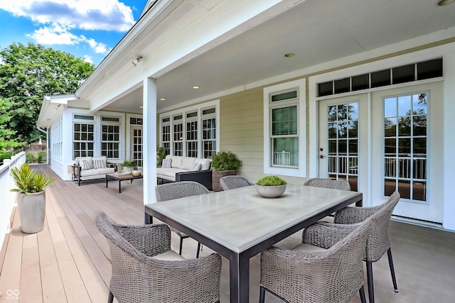 wooden terrace featuring an outdoor living space and outdoor dining space