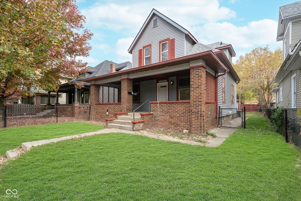 view of front of house with covered porch and a front lawn