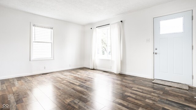 entrance foyer with wood-type flooring and a textured ceiling