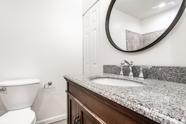 bathroom featuring toilet and vanity