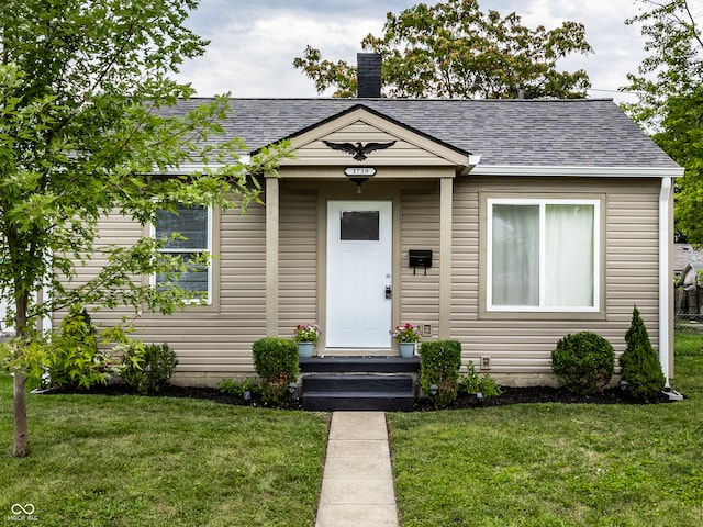 bungalow-style house featuring a front yard