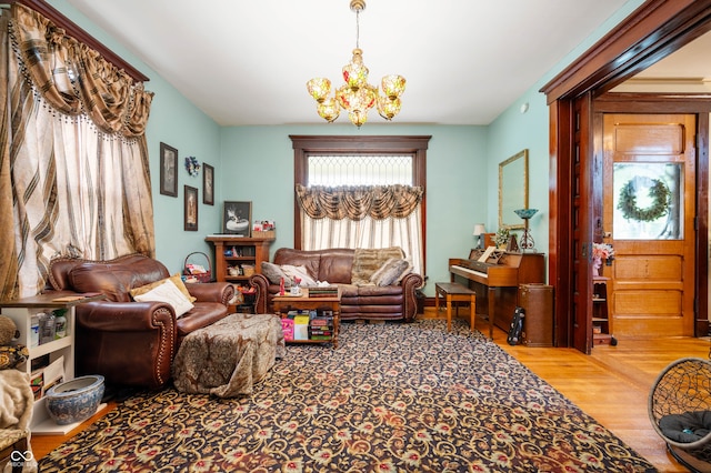 sitting room featuring a chandelier and wood-type flooring