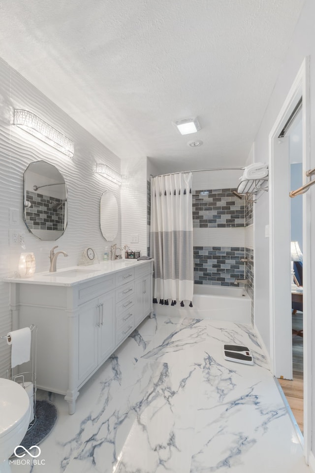 bathroom with double vanity, a textured ceiling, tile patterned flooring, and toilet