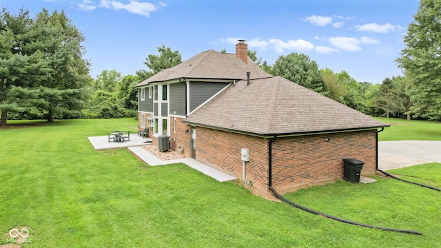 view of side of home with central AC, a lawn, and a patio